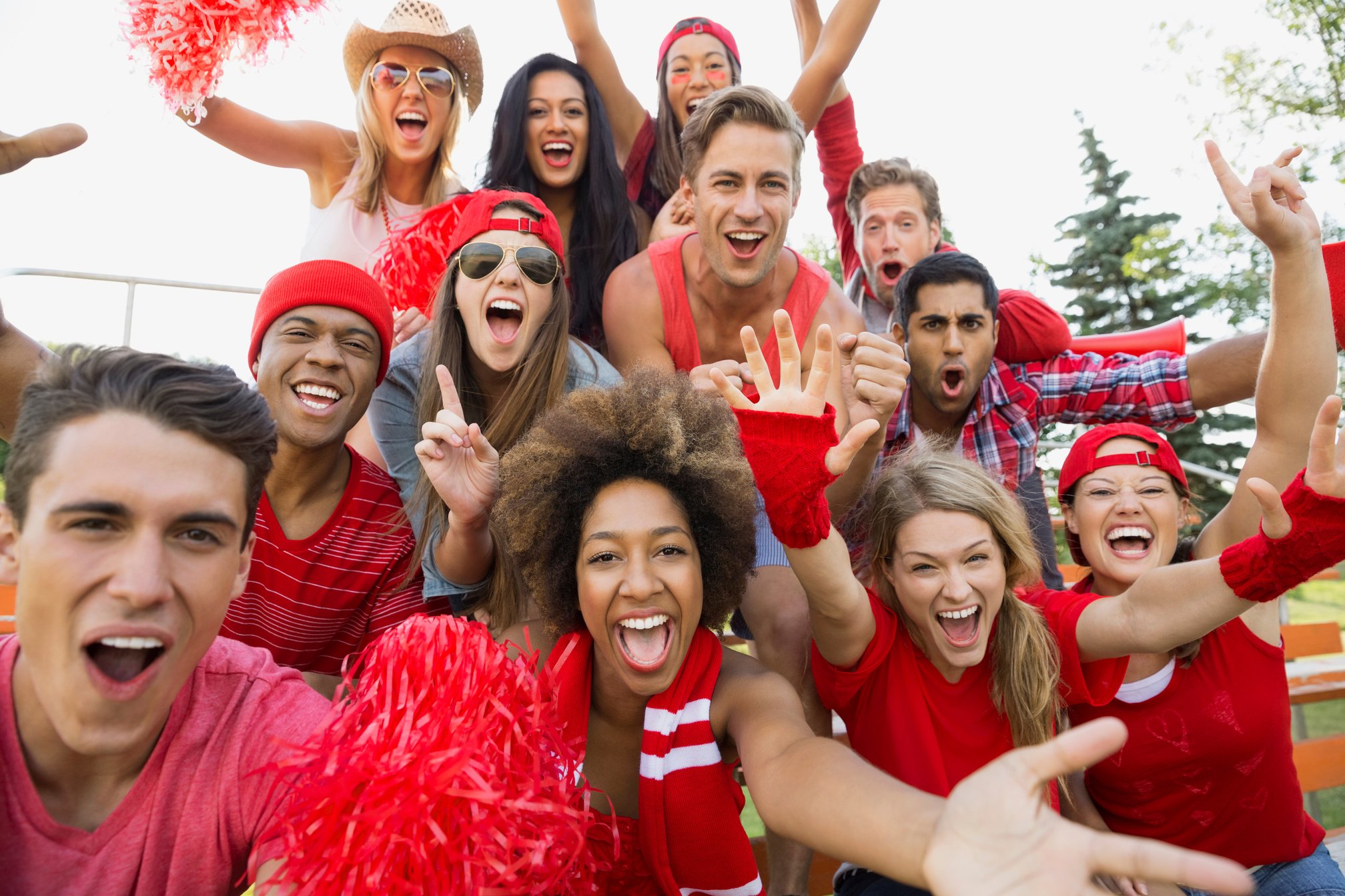 Friends cheering at sporting event